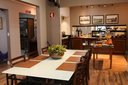 a dining room with a table and chairs at Hotel Rezende in Lambari
