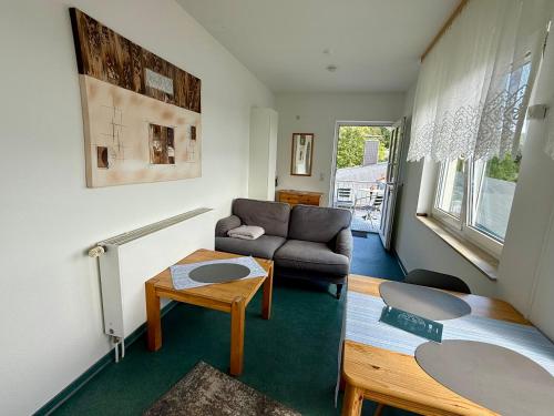 a living room with a couch and a table at Rosenhof in Binz in Binz