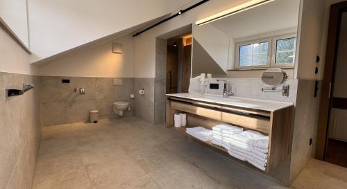 a bathroom with a sink and a toilet at Marktplatz Apartments Lofer in Lofer