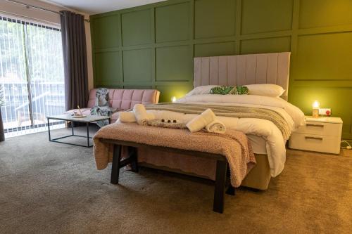 a large bedroom with a large bed and a table at Sundale House in Lurgan