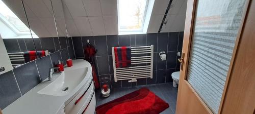a bathroom with a white tub and a red towel at Haus Haase in Prenzlau