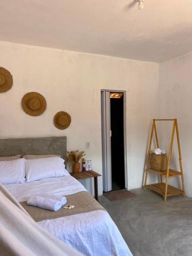 a bedroom with a bed and a table and a door at Yahweh Guriú Kite in Guriú