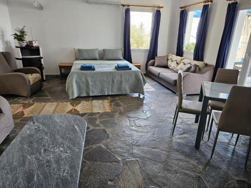 a living room with a bed and a couch at Ioannis Appartements Glossa in Glossa