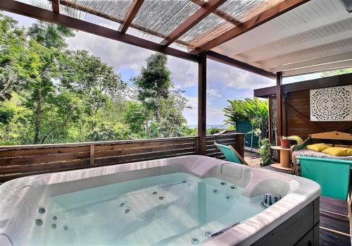 a jacuzzi tub on the deck of a house at EDEN FOREST VILLA in Pointe-Noire