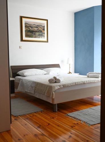 a bedroom with a bed with a teddy bear on it at Apartmani Filip i Jakov in Senj