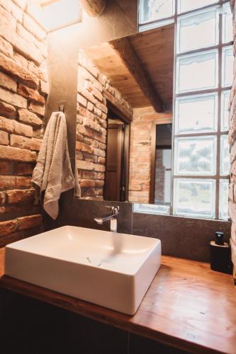a white sink in a bathroom with a window at Alpine Retreat in Borsa
