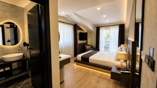 a hotel room with a bed and a sink at Rossa Marin Hotel in Darıca