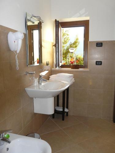 a bathroom with a sink and a mirror at Affittacamere Verger Plein Soleil in Saint-Pierre