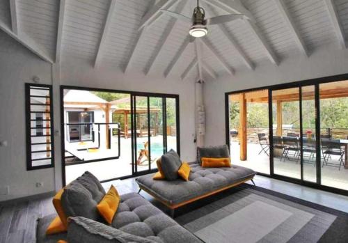 a living room with a couch and a table at EDEN FOREST VILLA in Pointe-Noire