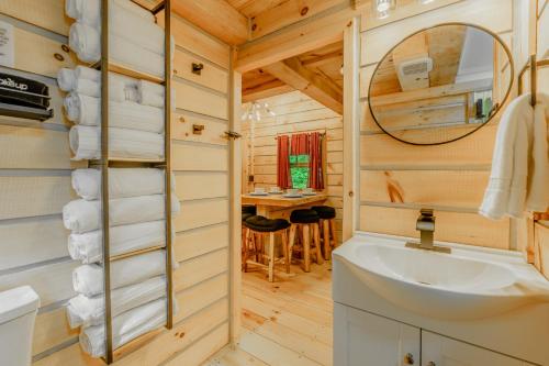 a bathroom with a sink and a mirror at Starry Nights in the Smokey Mountains with Hot Tub Pet Friendly Cabin A in Elizabethton