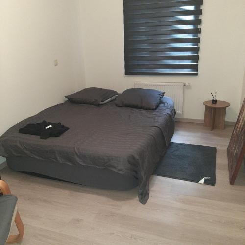 a bedroom with a large bed with a blue rug at Italian stile in Spa