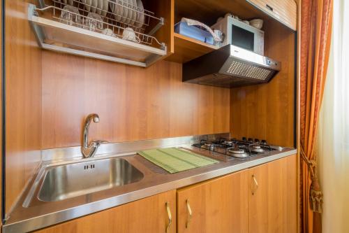 a kitchen with a sink and a stove at Residence Alberghiero Eolie in Lipari
