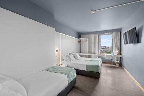 Cama ou camas em um quarto em Basic Braga by Axis