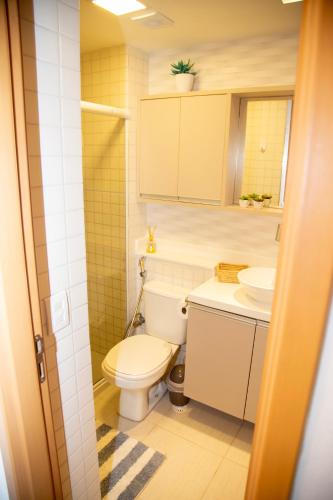 a bathroom with a toilet and a sink at Flat Resort Beira Mar Porto de Galinhas in Ipojuca