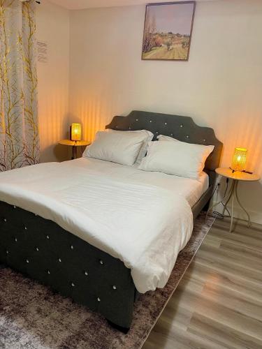 a bed with white sheets and pillows in a bedroom at Cozy 1-Bed Basement Suite in Calgary