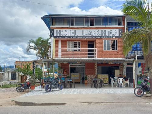 a hotel with motorcycles parked in front of it at Hotel y restaurante juanchito in Pitalito