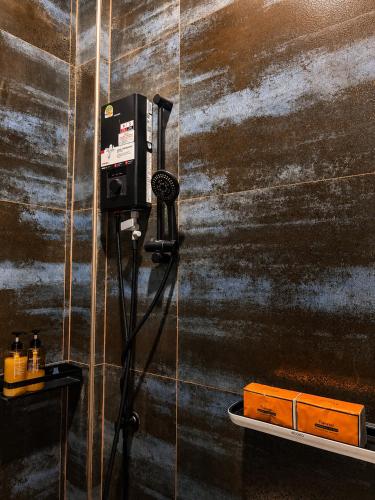 a bathroom with a pay phone on a wall at Jip Studio - 3mn ZenBeach - Garden View in Haad Chao Phao
