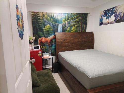 a bedroom with a bed and a painting on the wall at Dubbo Farm in Dubbo