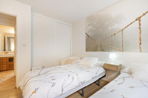 a bedroom with a bed and a bridge painting on the wall at Acogedor chalet rústico in Cambre