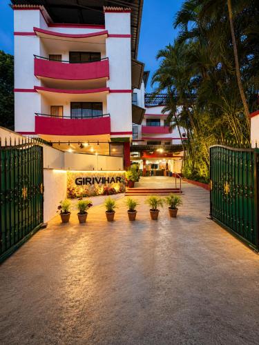 a hotel with a sign in front of a building at Girivihar Holiday Club - Pure Veg in Lonavala