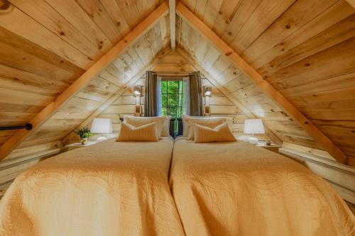 a bedroom with two beds in a attic at Starry Nights in the Smokey Mountains with Hot Tub Pet Friendly Cabin A in Elizabethton