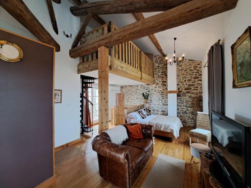 a living room with a couch and a bed at La Maison du Canal- vue Canal- L'ère du Temps in Homps