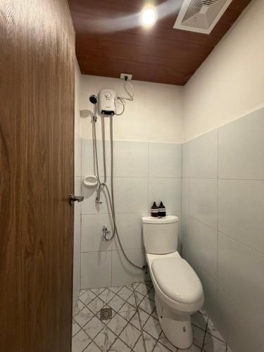 a bathroom with a toilet and a shower at Bahay El Nido in El Nido