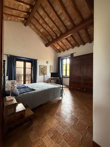 a bedroom with a bed and a large window at B&B la boffalora in Zaffignano
