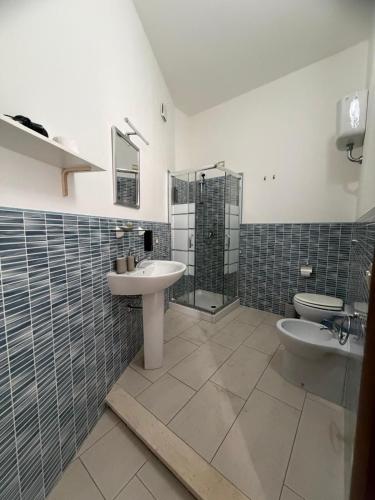 a bathroom with a sink and a toilet and a shower at ELEGANCE GIBA Rooms in Giba