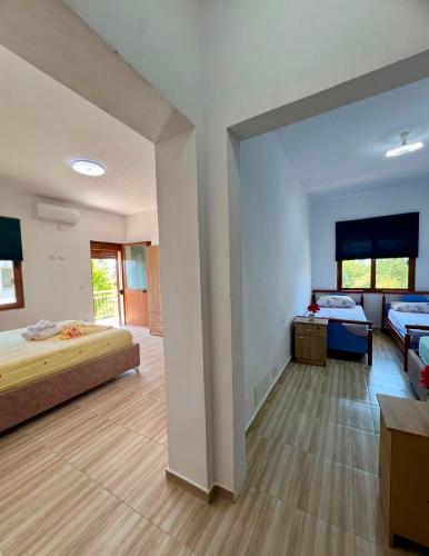a large room with two beds and a couch at Villa Kalaj in Baks-Rrjoll
