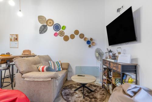 a living room with a couch and a flat screen tv at Casa Do Renque in Arzúa