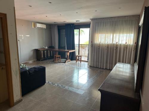 a living room with a couch and a table at Isla de los Pensamientos in Cullera