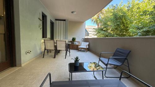 an outdoor patio with chairs and a table on a balcony at Crystal House in Montesilvano