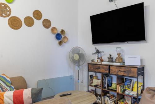 a living room with a flat screen tv on a wall at Casa Do Renque in Arzúa