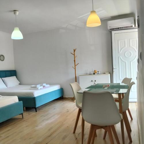 a room with a bed and a table and chairs at Kostaki spila apartment in Himare