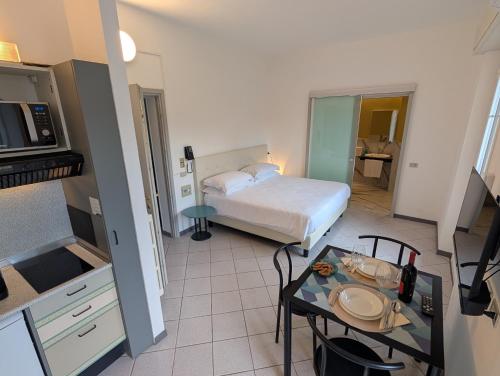 a small room with a bed and a table in it at Residence Cosy Baveno in Baveno