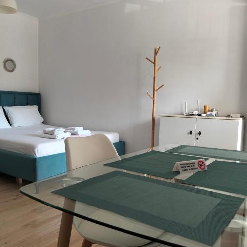 a room with a glass table and a bed at Kostaki spila apartment in Himare