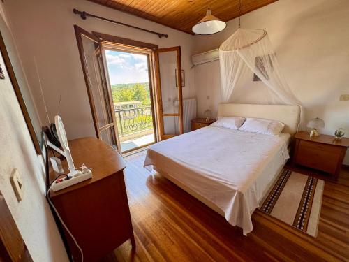 a bedroom with a bed and a phone and a window at Zeba apartment 200m from the Sea in Dhílesi