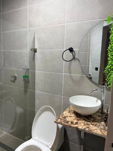 a bathroom with a toilet and a sink at cabaña emanuel in Sopetrán