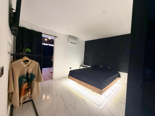 a bedroom with a bed and a large window at cabaña emanuel in Sopetrán