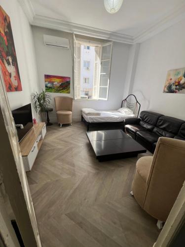 a living room with a couch and a table at Lafayette Apartment in Tunis