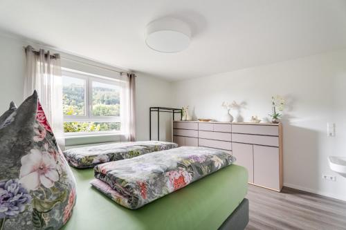 a bedroom with two beds and a window at Ferienwohnung Waldrose in Oberharmersbach