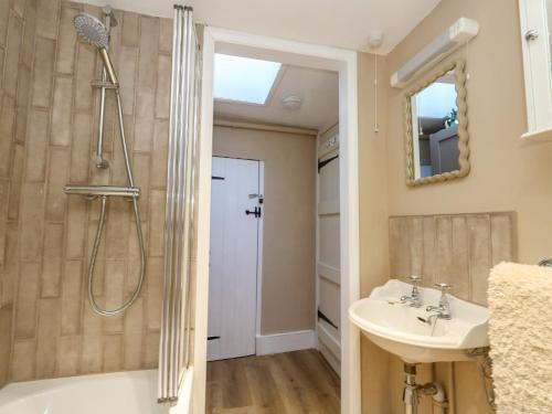a bathroom with a shower and a sink at Little Wickers in Wareham