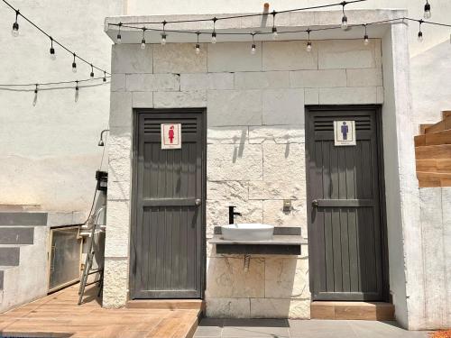 a bathroom with two doors and a sink at Casa Tulipán in Monterrey
