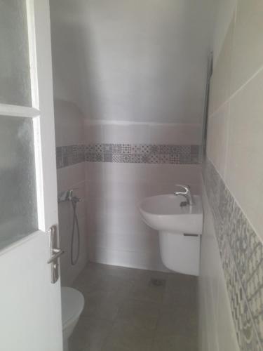 a bathroom with a sink and a toilet at Au Soleil le Vent in La Goulette