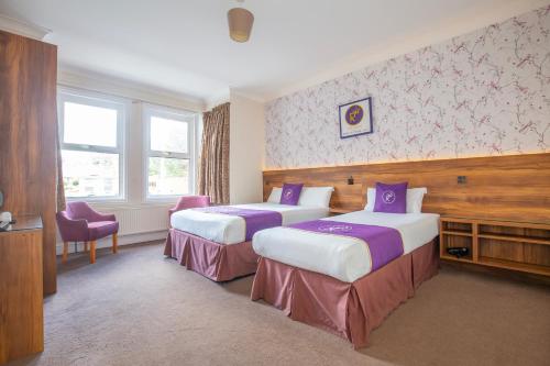 a hotel room with two beds and a window at Revado Hotel, Norwich City Centre in Norwich