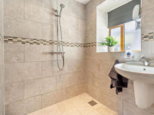 a bathroom with a sink and a shower at 4 Bed in Llanidloes oc-95968 in Van