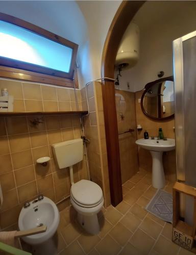 a bathroom with a toilet and a sink at La Cascinassa in Tagliolo Monferrato