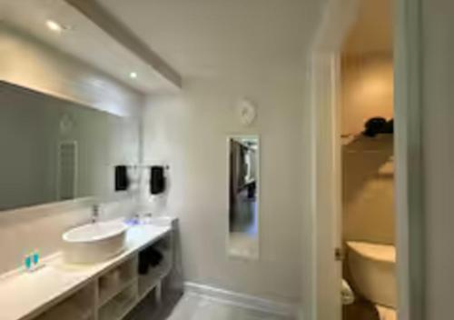 a bathroom with a sink and a tub and a toilet at Lyrios Vacation Rentals - Legacy in Kissimmee