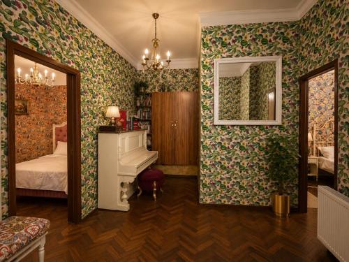 a bedroom with a bed and a white piano at Belli Siciliani Bed&Breakfast in Bucharest